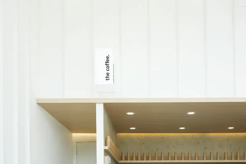 Interior of the Frame and Focus optician salon showing modern shelves