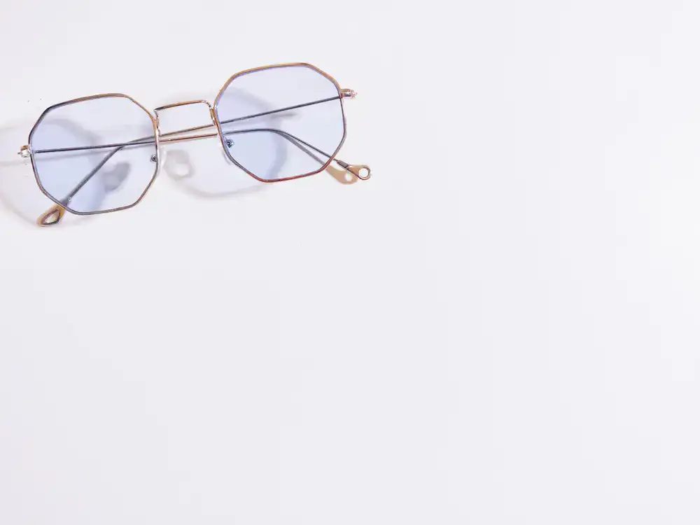 Editorial portrait of a person wearing stylish geometric optical frames
