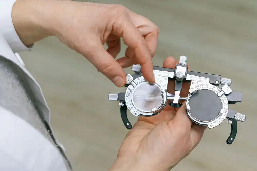 Optician carefully measuring and fitting lenses into an elegant frame